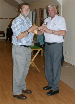 Bert presents Lionel with the trophy for winning the skittles 